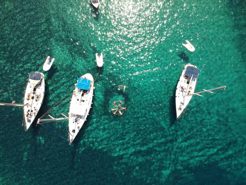 Adamantas: Milos Sightseeing Sailboat Cruise - Sykia Cave: green waters, dinghy entry, and a salt lake under a skylight
