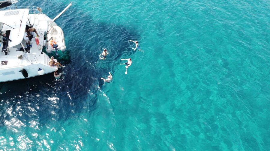 Athens: Catamaran Cruise with Fresh Lunch and Wine - Hydroussa islet swim stop: the best kind of effort, jump and snorkel