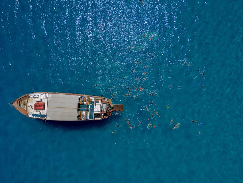 Faliraki : Transfer & Cruise to Lindos with 3 Swimming Stops - What is included, what costs extra, and how the onboard bar fits