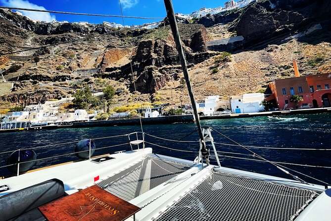 Half Day Premium Catamaran Cruise in Santorini including Oia - Limestone formations and clear water: the quiet middle stop