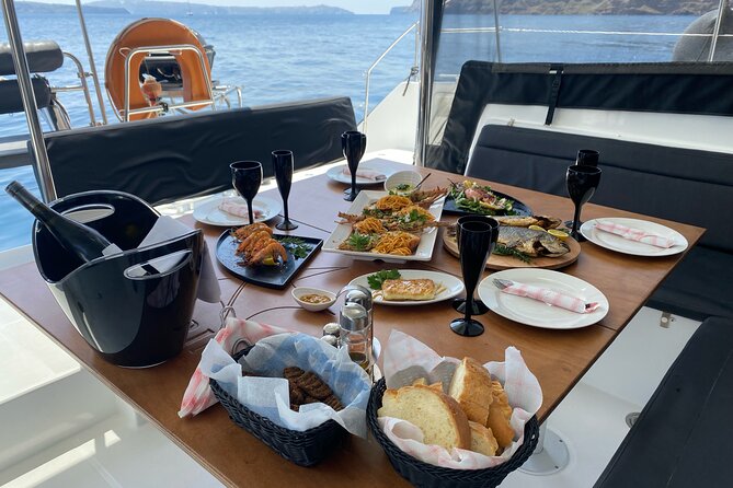 Half Day Premium Catamaran Cruise in Santorini including Oia - Thirassia island break: swim, snorkel, and onboard meal prep