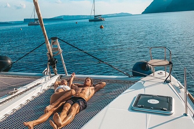 Half Day Premium Catamaran Cruise in Santorini including Oia - The Oia highlight: photo time near Ammoudi and views of the Venetian lighthouse