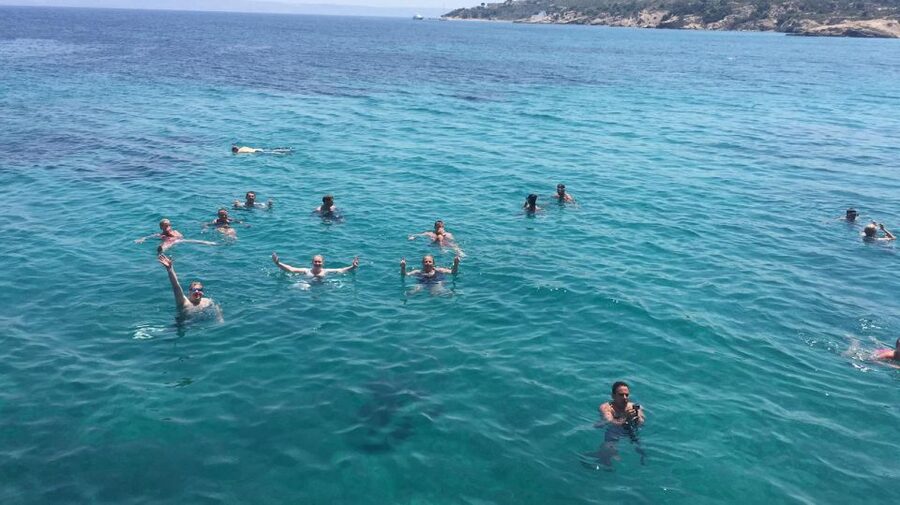 Kos Town: Kalymnos & Pserimos Day Cruise & Optional Transfer - The crew vibe: fun sailing, music, and dolphin-spotting attempts