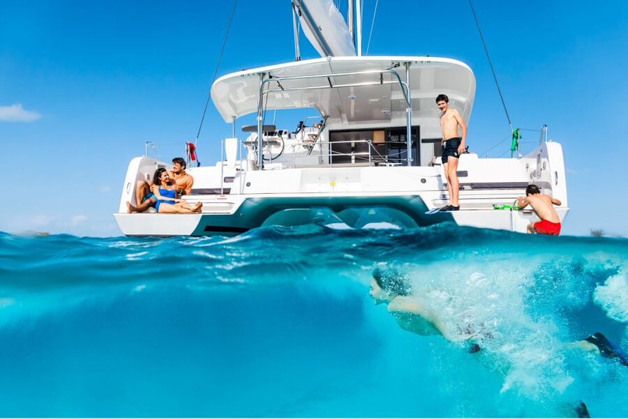Mykonos: Catamaran Cruise with Lunch, Drinks and Transfer - Rhenia Island cove: swimming, snorkeling, SUP, and lunch at anchor