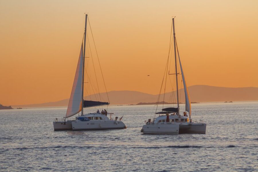Mykonos: Catamaran Cruise with Lunch, Drinks and Transfer - Sailing back to Mykonos: windmills, town views, and sunset timing
