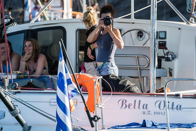 Santorini Adventurous Catamaran Experience with Snorkeling - Akrotiri cliffs and the Venetian lighthouse pass