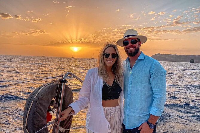 Santorini Catamaran Cruise with Greek Meal, Open-Bar and Sunset - Sailing Views: Caldera Cliffs, Lighthouse Passing, and White Beach Area