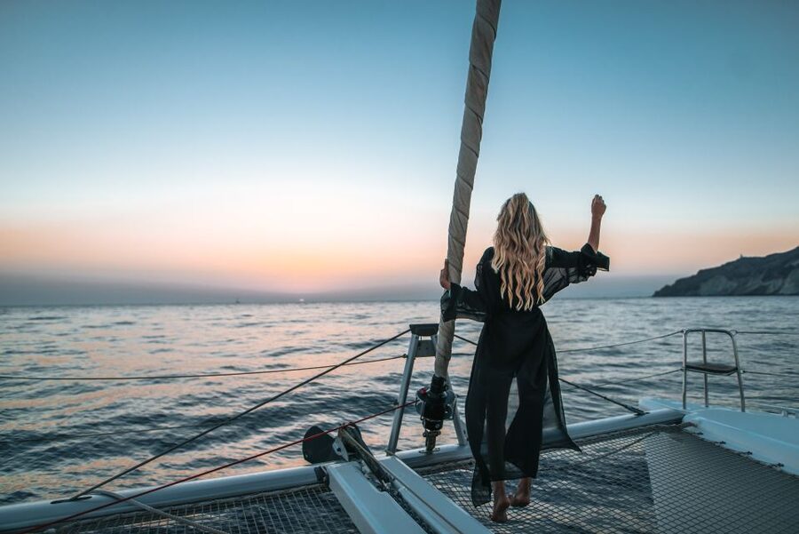 Santorini Catamaran Cruise with Swimming, Meal and Open Bar - Passing White Beach and the Akrotiri Lighthouse views