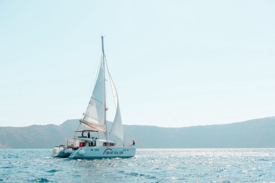 Santorini: Catamaran Tour with BBQ Meal and Unlimited Drinks - Sunset from below Oia: why the water view hits different