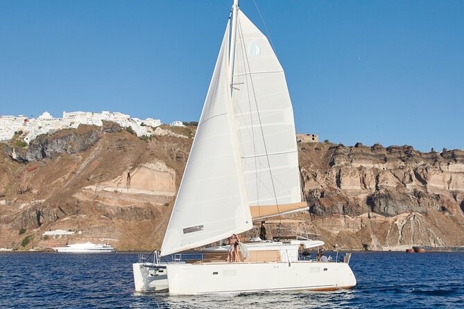 Santorini Platinum Catamaran Cruise with Meal, BBQ and Open Bar - Red Beach: 15 Minutes of Color, Cliffs, and Quick Stops