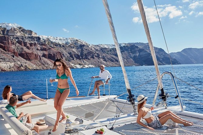 Santorini Sunset Luxury Sailing Catamaran Cruise with BBQ, drinks, transfer - Red Beach swim and snorkel: short stop, big volcanic color