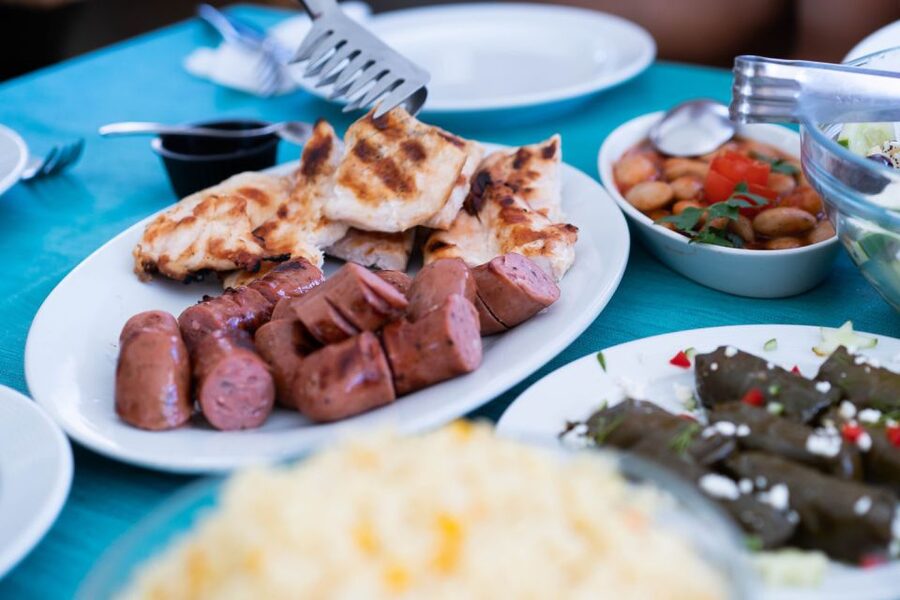 Santorini: Traditional Wooden Boat Tour with Meal and Wine - Onboard Greek lunch or dinner with local white wine