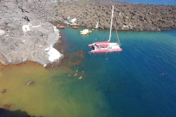 Sunset Sailing Catamaran Cruise in Santorini with BBQ and Drinks - Red Beach swim stop: shorter, scenic, and built for snorkeling